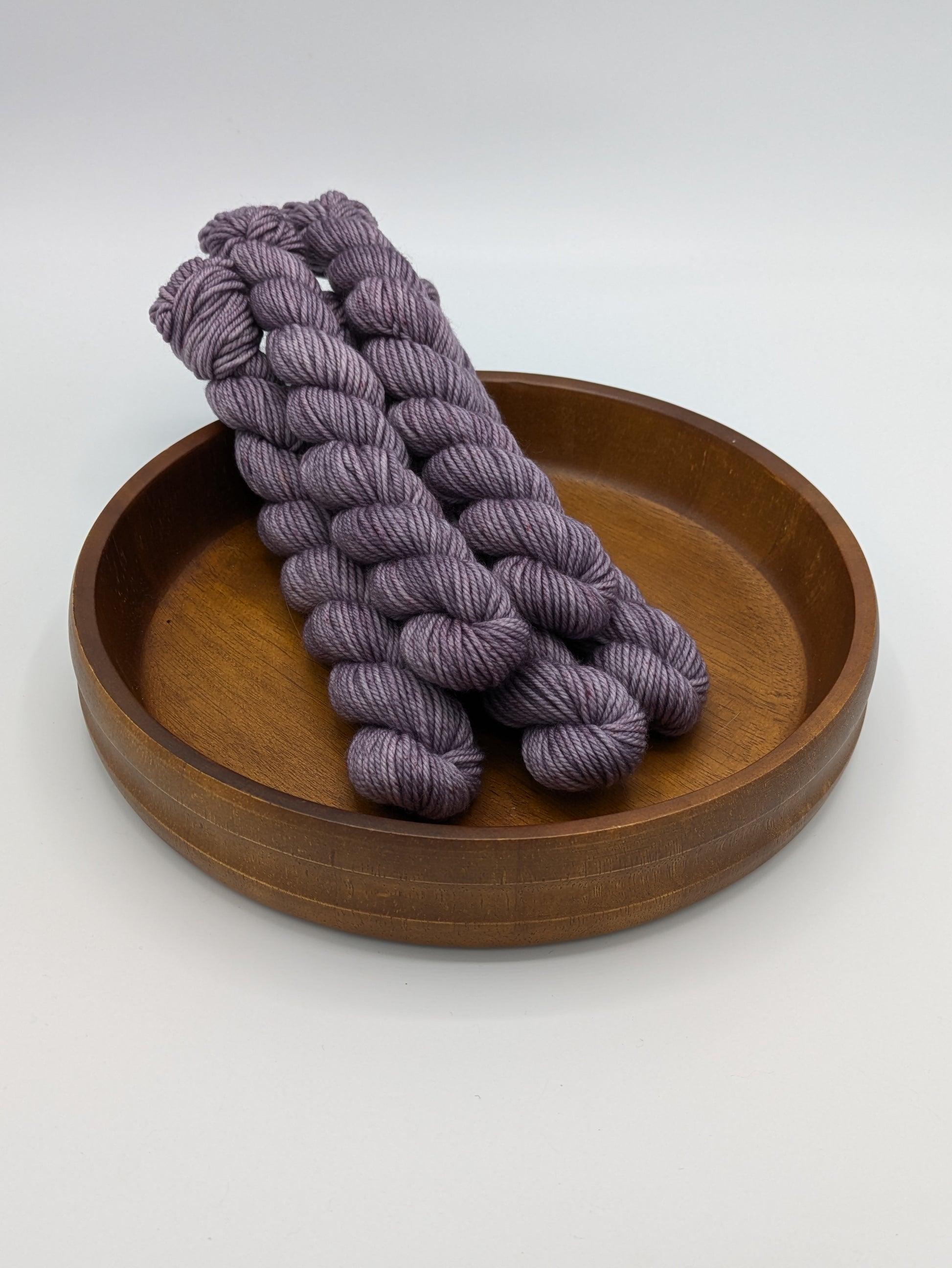 Skeins of Amethyst DK weight yarn, a soft purple color