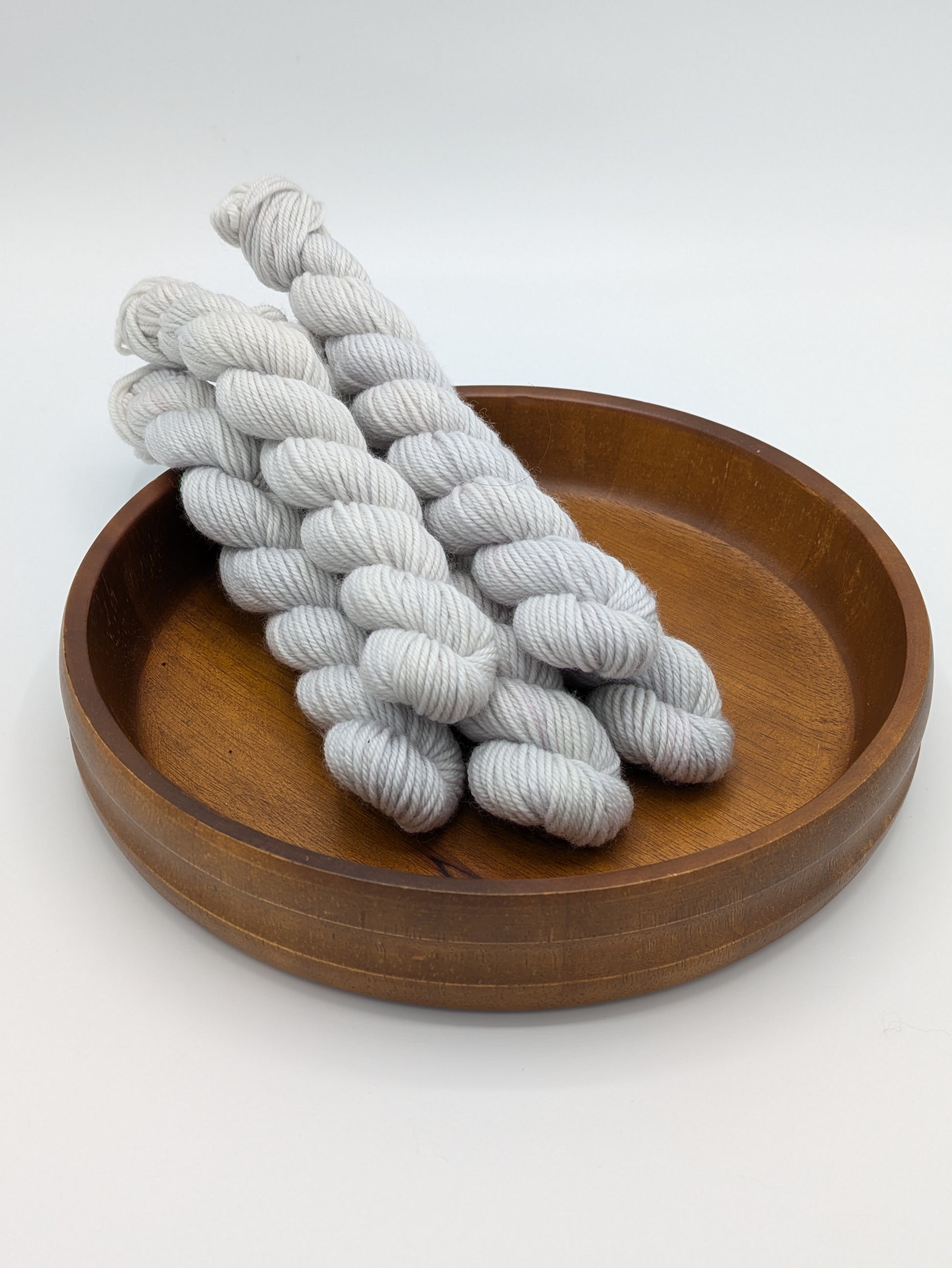 Frost DK weight mini skeins showcasing a neutral gray blue color