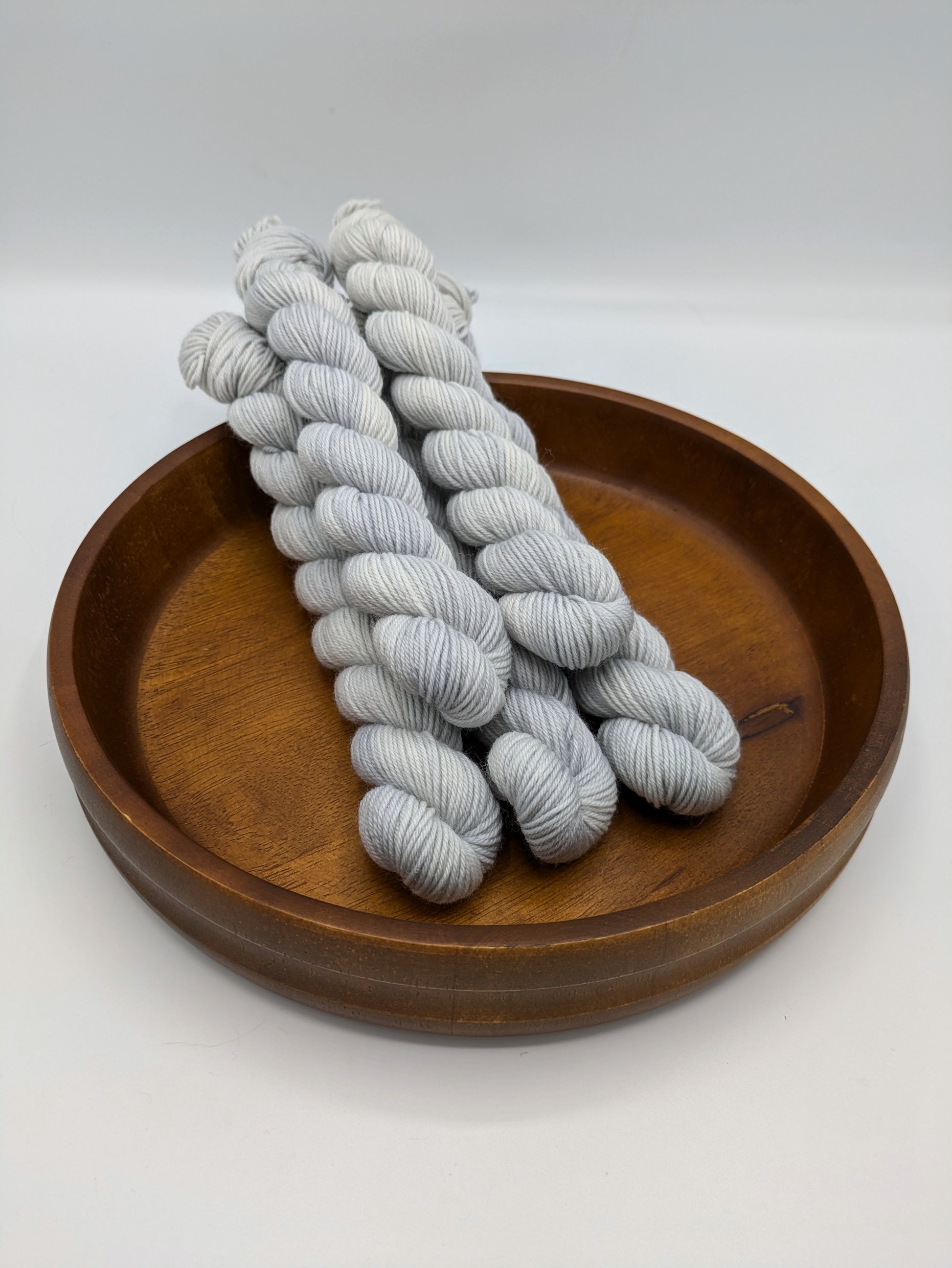 Frost fingering weight mini skeins showcasing a neutral gray blue color
