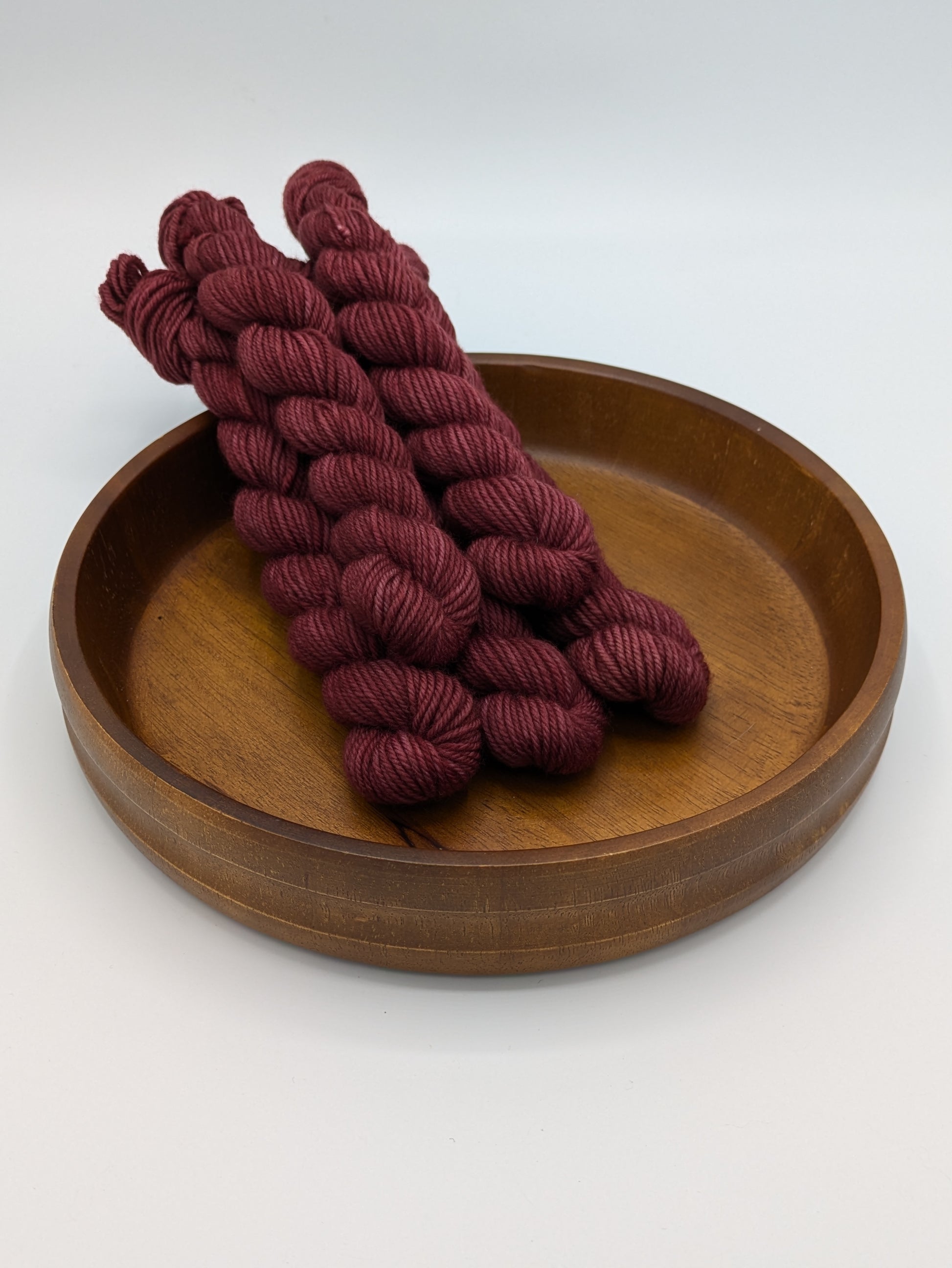 Skeins of Merlot DK weight yarn, a rich wine color
