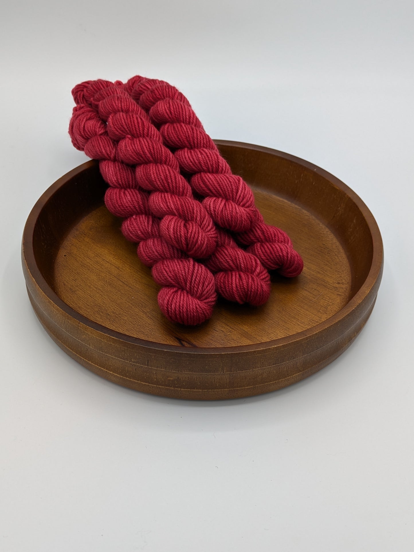 A Good Red Yarn mini skeins in DK weight, showing vibrant red color