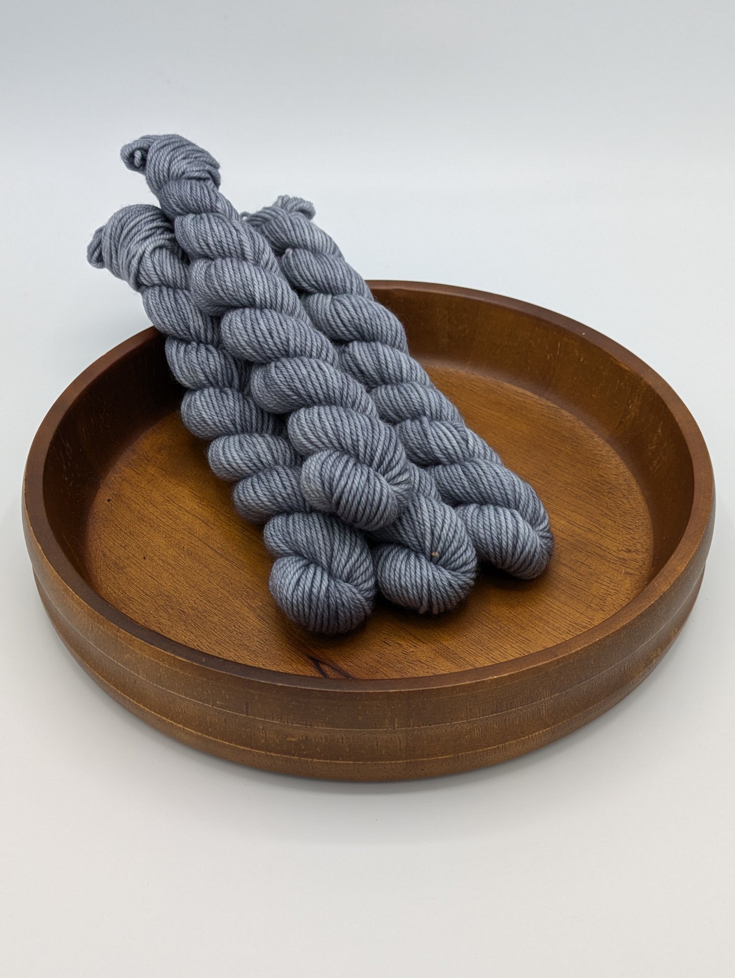 Charcoal DK weight mini skeins showcasing a neutral dark gray color