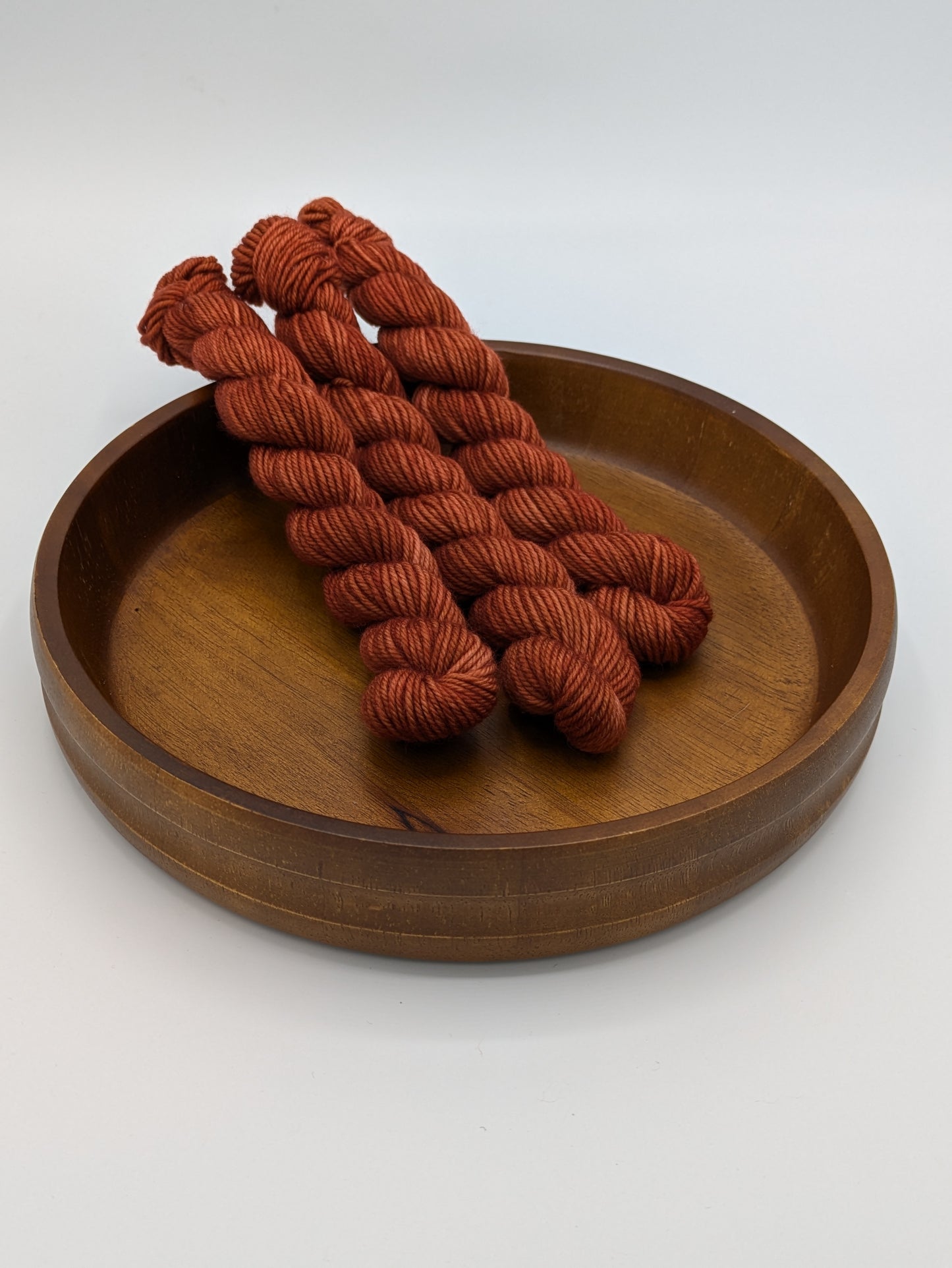 Cinnabar Yarn mini skeins in DK weight, showing a burnt orange color