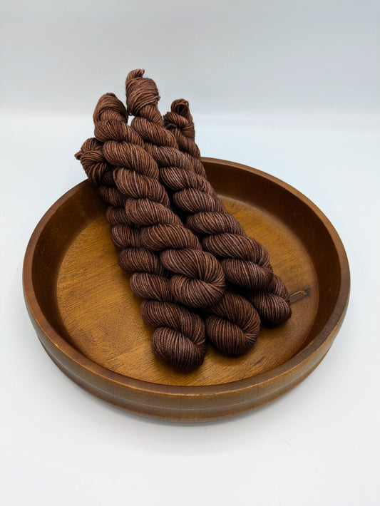 Cocoa fingering weight mini skeins showcasing a rich chocolate color