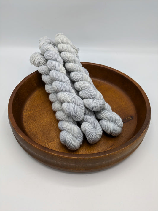 Frost fingering weight mini skeins showcasing a neutral gray blue color 