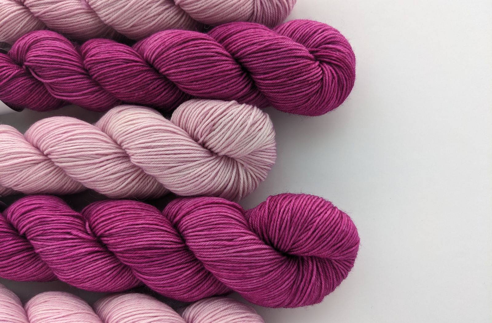 Image of sock yarn skeins showing pink and magenta yarn colors