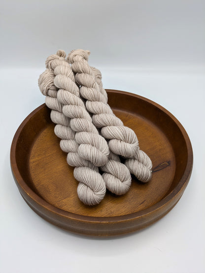 Oatmeal fingering weight mini skeins showcasing a neutral cream color with tan undertones