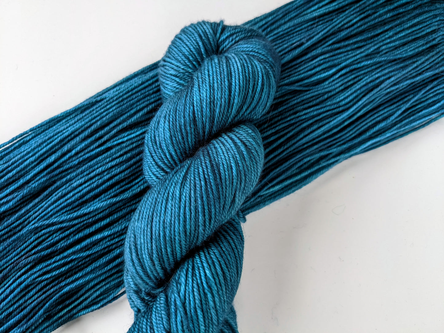 Tealicious Yarn skein in DK weight, showcasing vibrant teal color