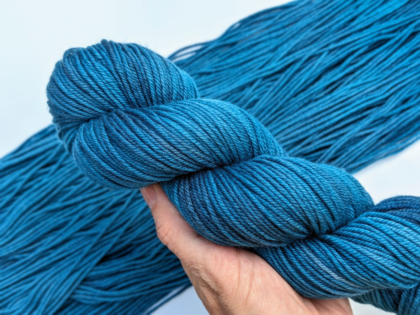 Tealicious Yarn skein in non-superwash DK weight, showcasing vibrant teal color