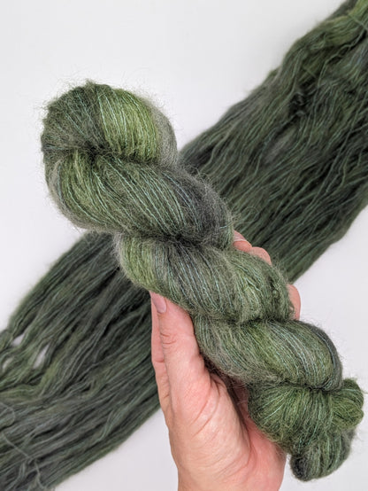 Fir Yarn skein in suri silk weight, showcasing rich green color