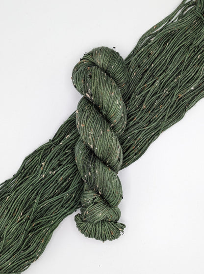 Fir Yarn skein in tweed DK weight, showcasing rich green color