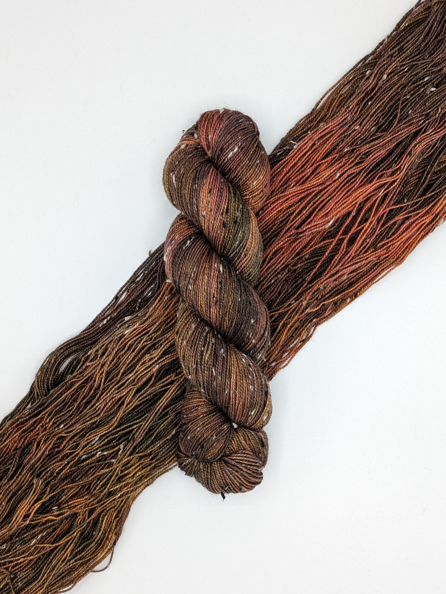 Mahogany Yarn Skein in tweed fingering weight, showcasing rich brown tones