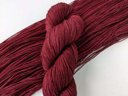 Merlot Yarn in fingering weight, showcasing deep wine color