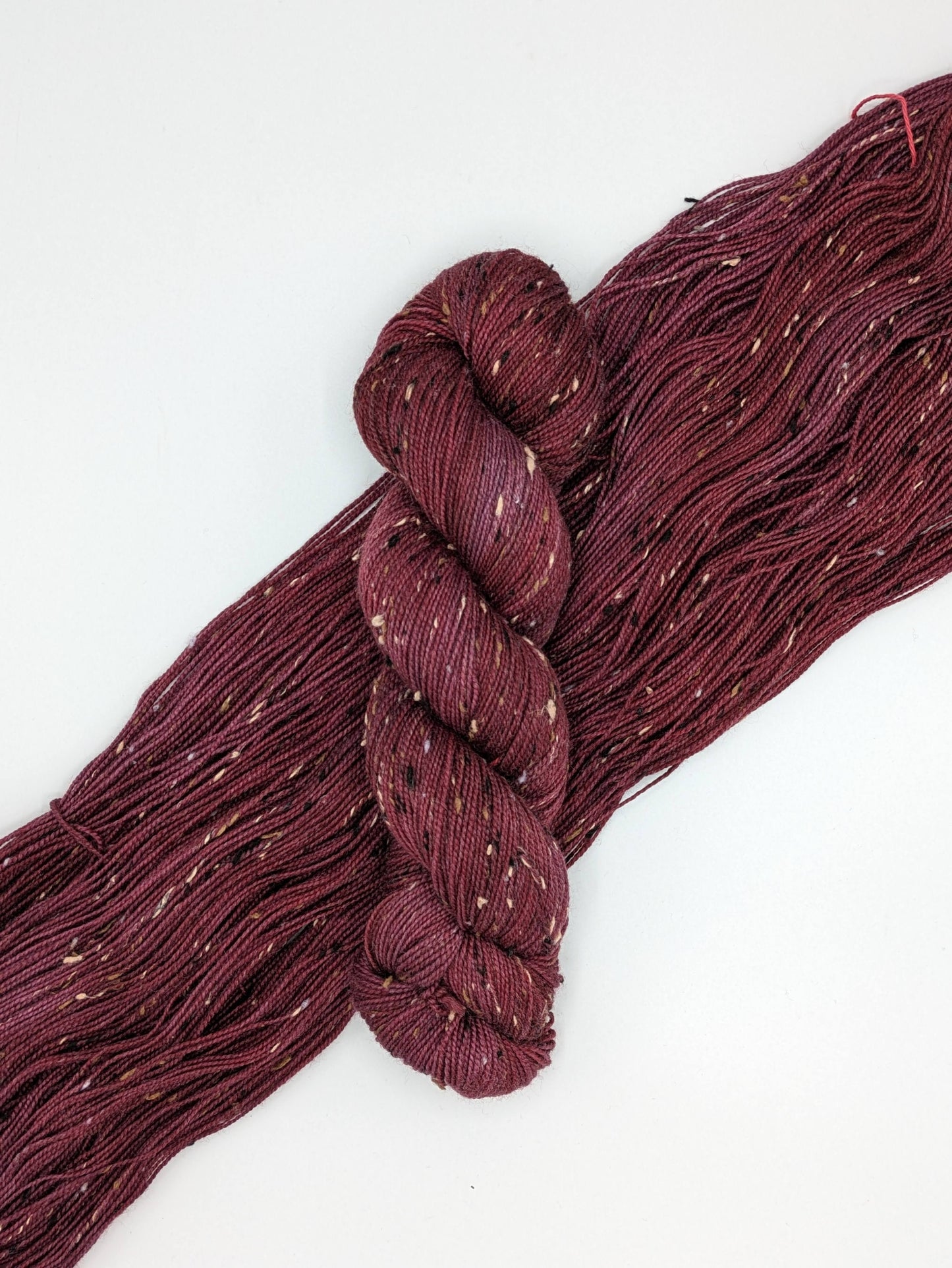 Merlot Yarn in tweed fingering weight, showcasing deep wine color