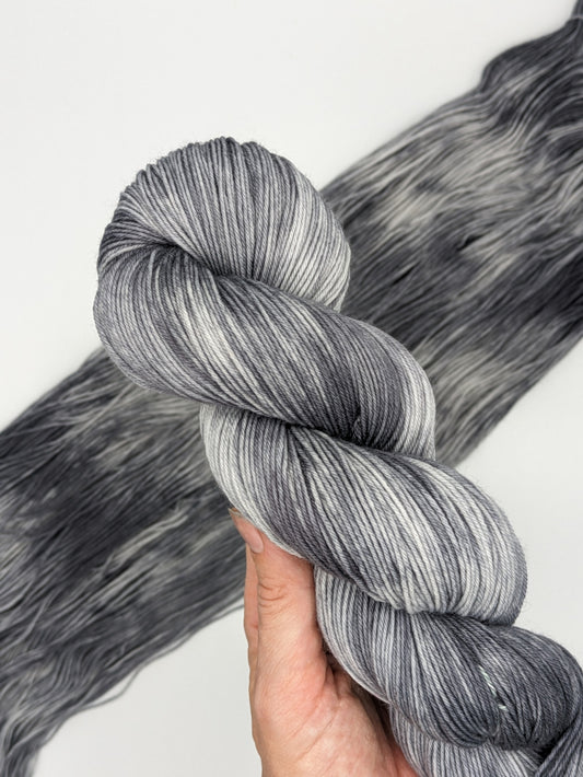 Newsprint Yarn in fingering weight, showcasing black and white variegated colors