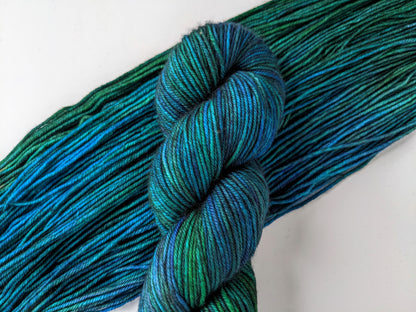 eacock Yarn in DK weight, showcasing vibrant blue and green hues