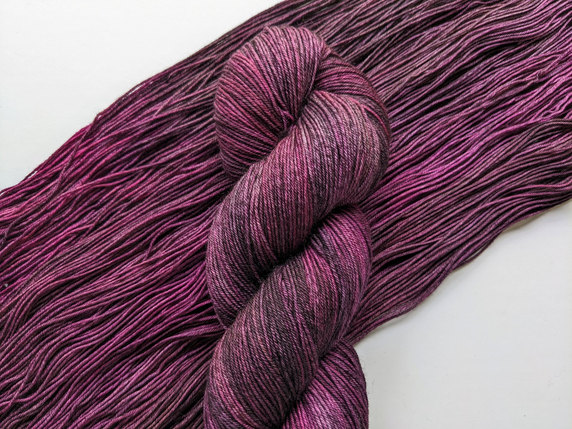 Purple Haze Yarn skein in fingering weight, showcasing vibrant purple hues