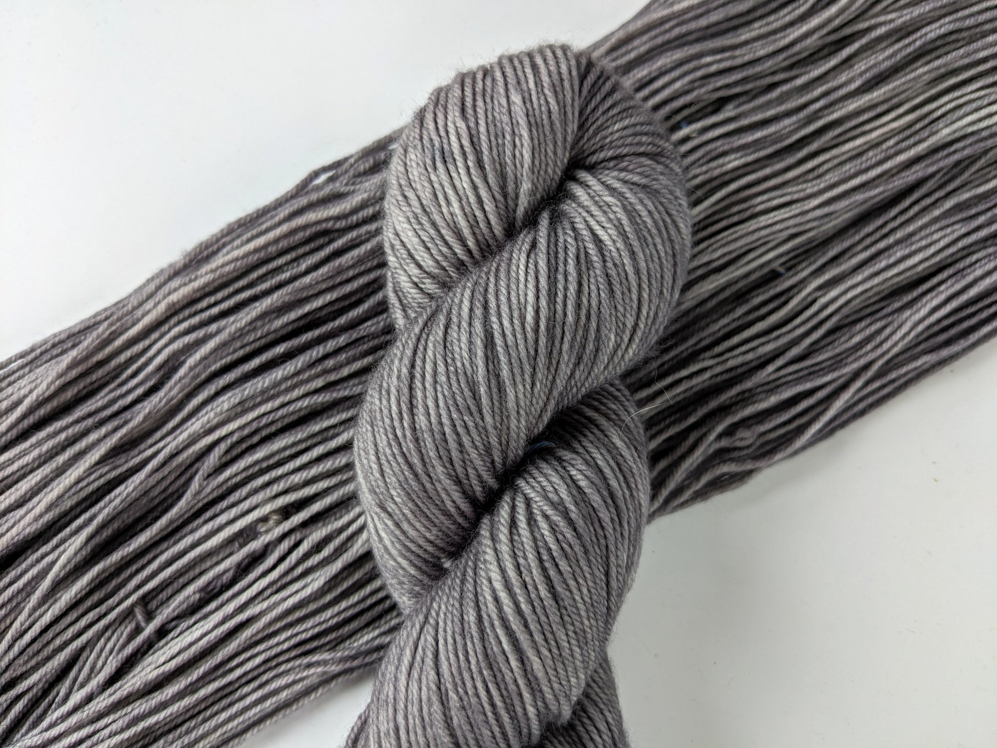 Silver Mist Yarn in DK weight, showcasing a soft grey color