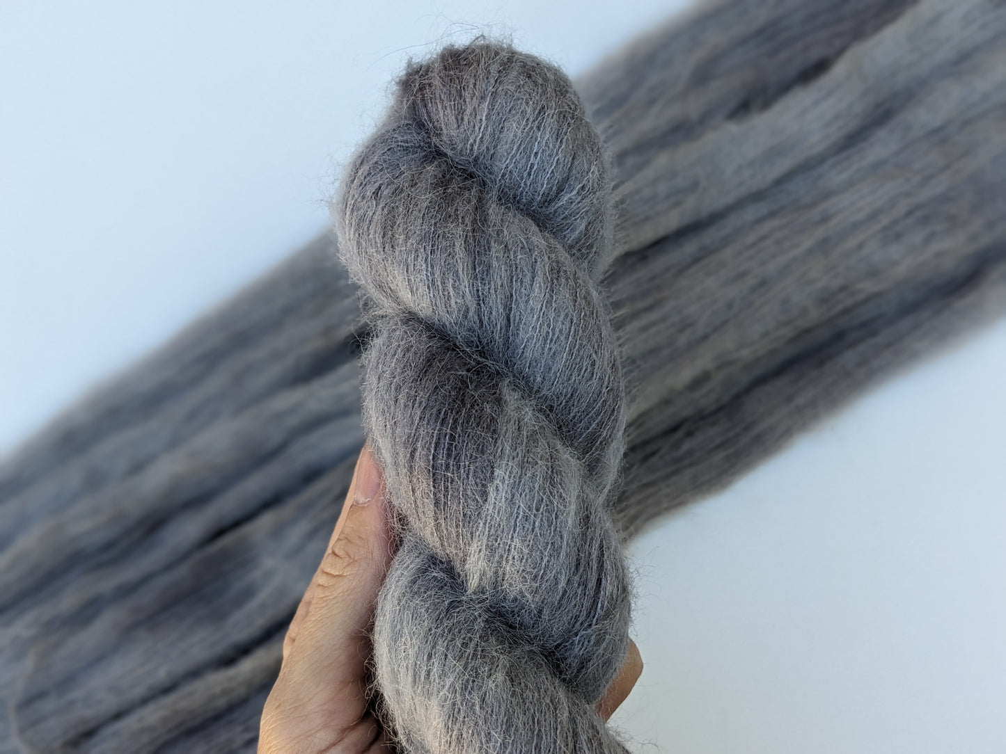 Silver Mist Yarn in suri silk, showcasing a soft grey color