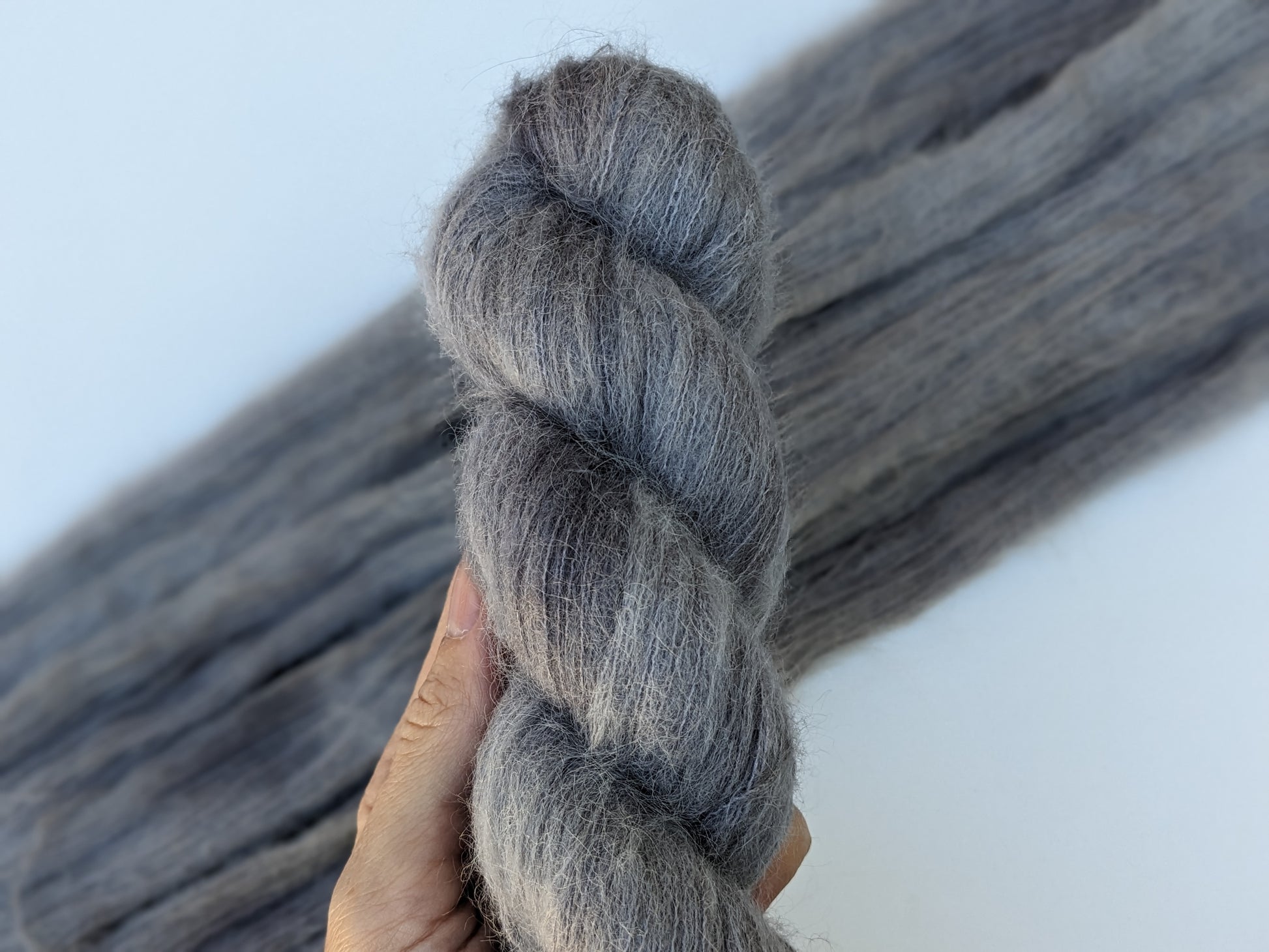 Silver Mist Yarn in suri silk, showcasing a soft grey color