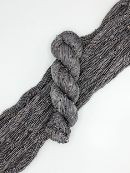 Silver Mist Yarn in tweed fingering weight, showcasing a soft grey color