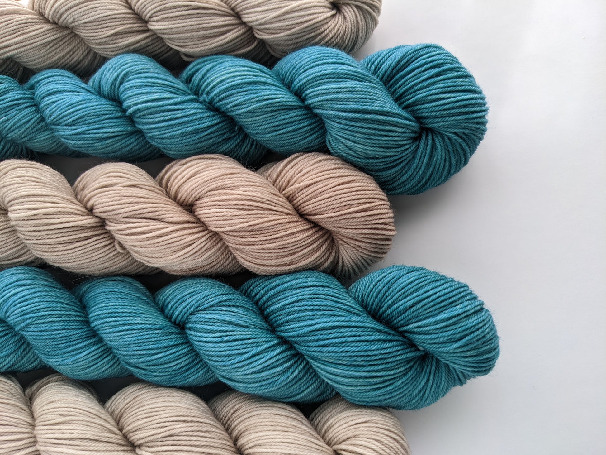 Image of sock yarn skeins showing blue and tan yarn colors