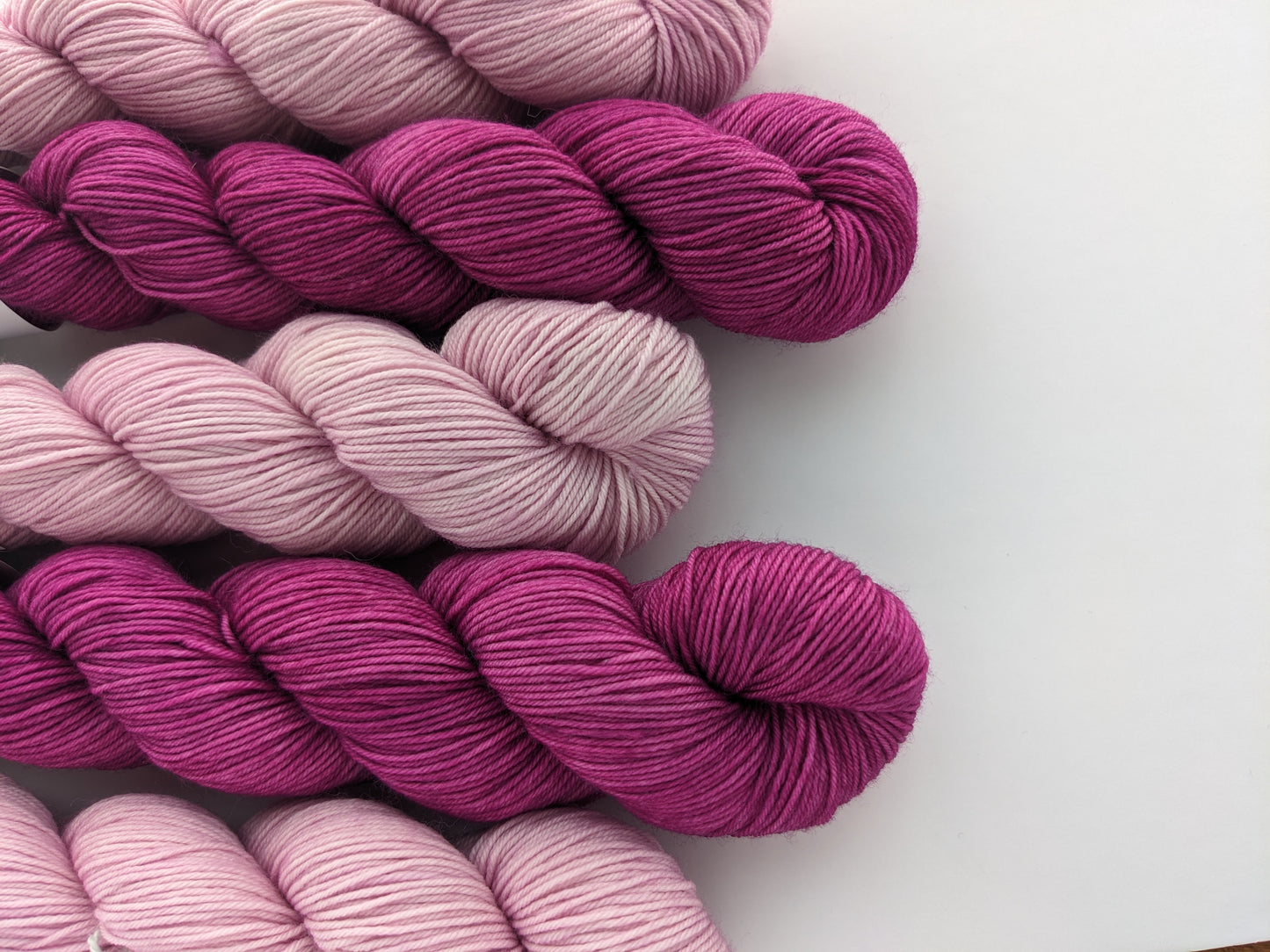 Image of sock yarn skeins showing pink and magenta yarn colors